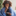 Woman sneezing and looking at a thermometer 